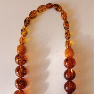 Mixed amber and composite round beads necklace 26" length.